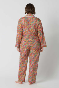 A Lady Wearing Plus Size Nell, Annie, & May Long Sleeve Classic Woven Tana Lawn® Pj Set Made With Liberty Fabrics in a back view pose