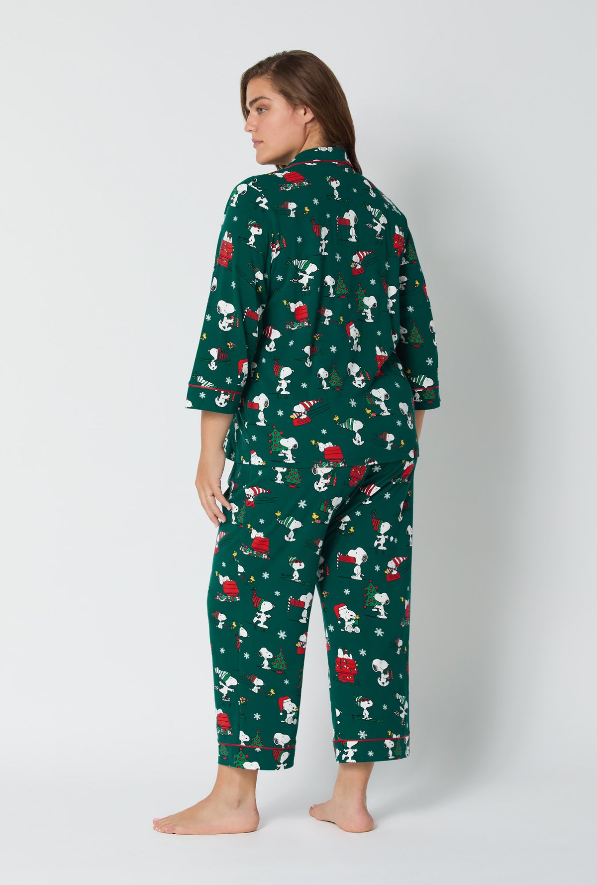 A lady wearing ®Snoopy's Holiday Fun 3/4 Sleeve Classic Stretch Jersey Cropped Pj Set