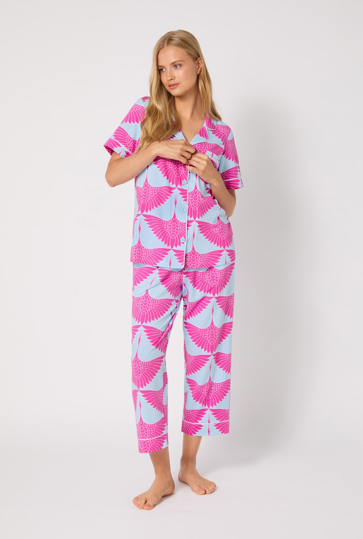 A lady wearing BedHead X Trina Turk Cranes Short Sleeve Classic Stretch Jersey Cropped PJ Set