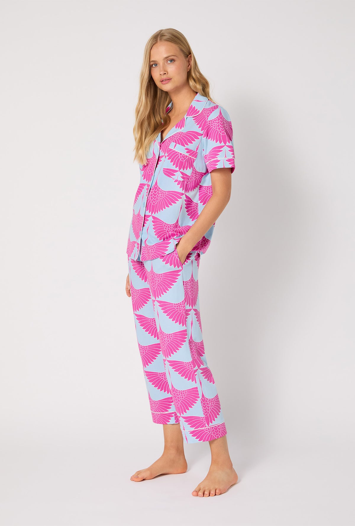 A lady wearing BedHead X Trina Turk Cranes Short Sleeve Classic Stretch Jersey Cropped PJ Set