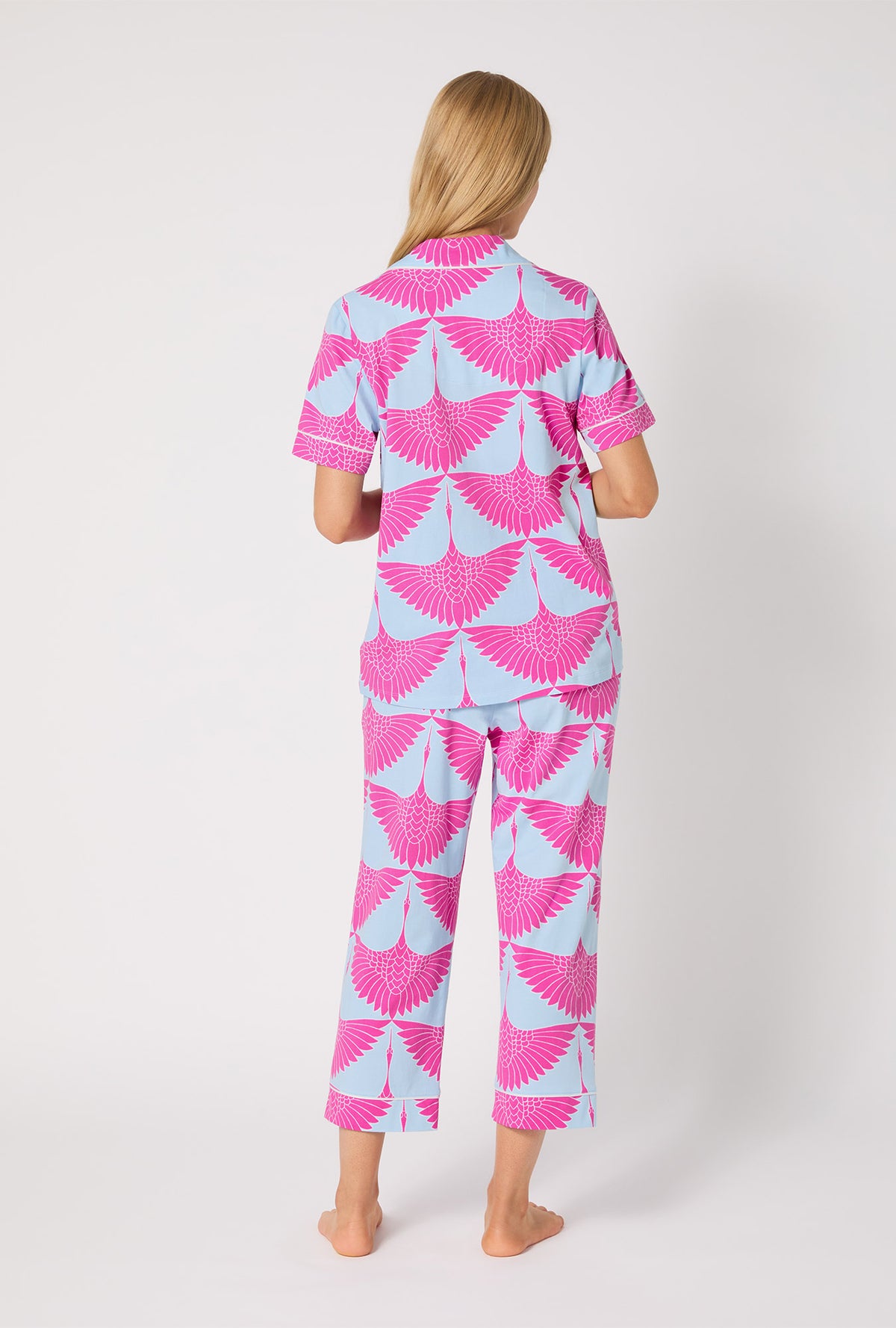 A lady wearing BedHead X Trina Turk Cranes Short Sleeve Classic Stretch Jersey Cropped PJ Set