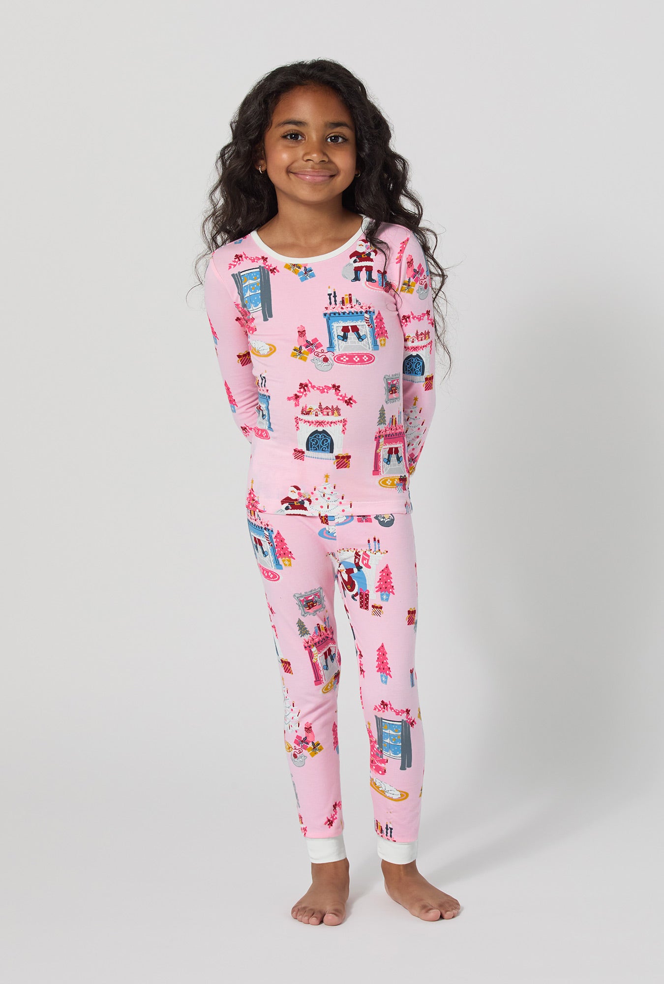 A girl wearing Must Be Santa Long Sleeve Stretch Jersey Kids Pj Set