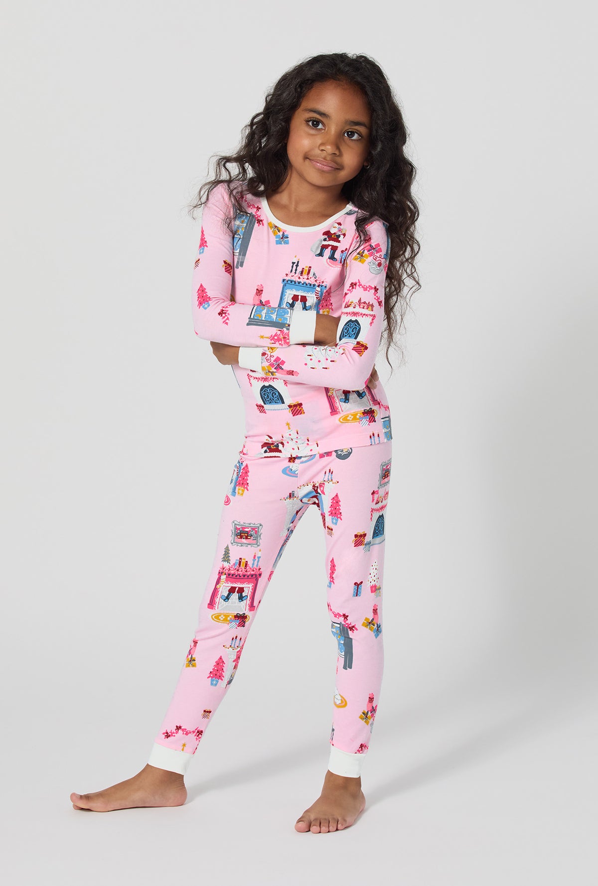 A girl wearing Must Be Santa Long Sleeve Stretch Jersey Kids Pj Set
