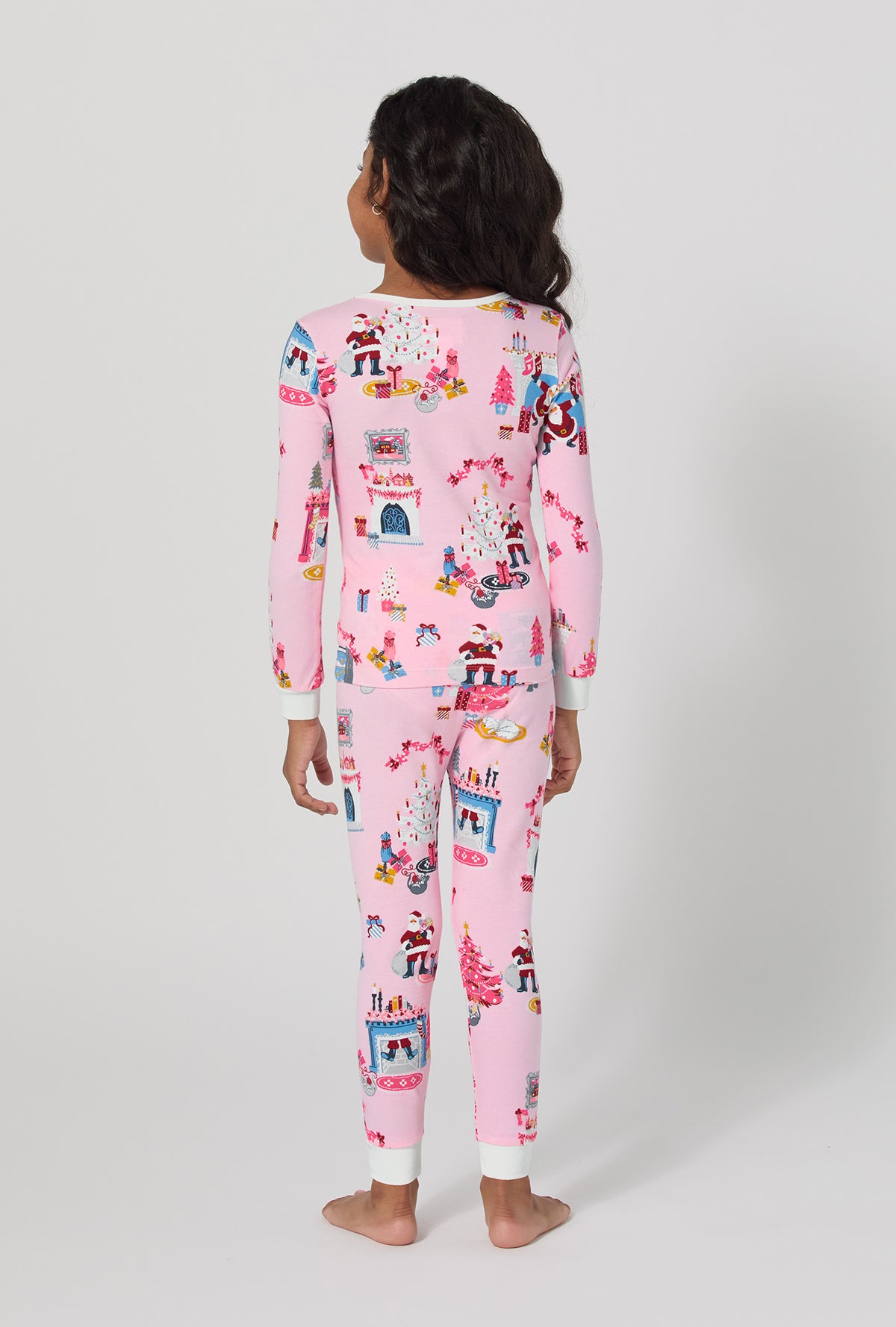 A girl wearing Must Be Santa Long Sleeve Stretch Jersey Kids Pj Set