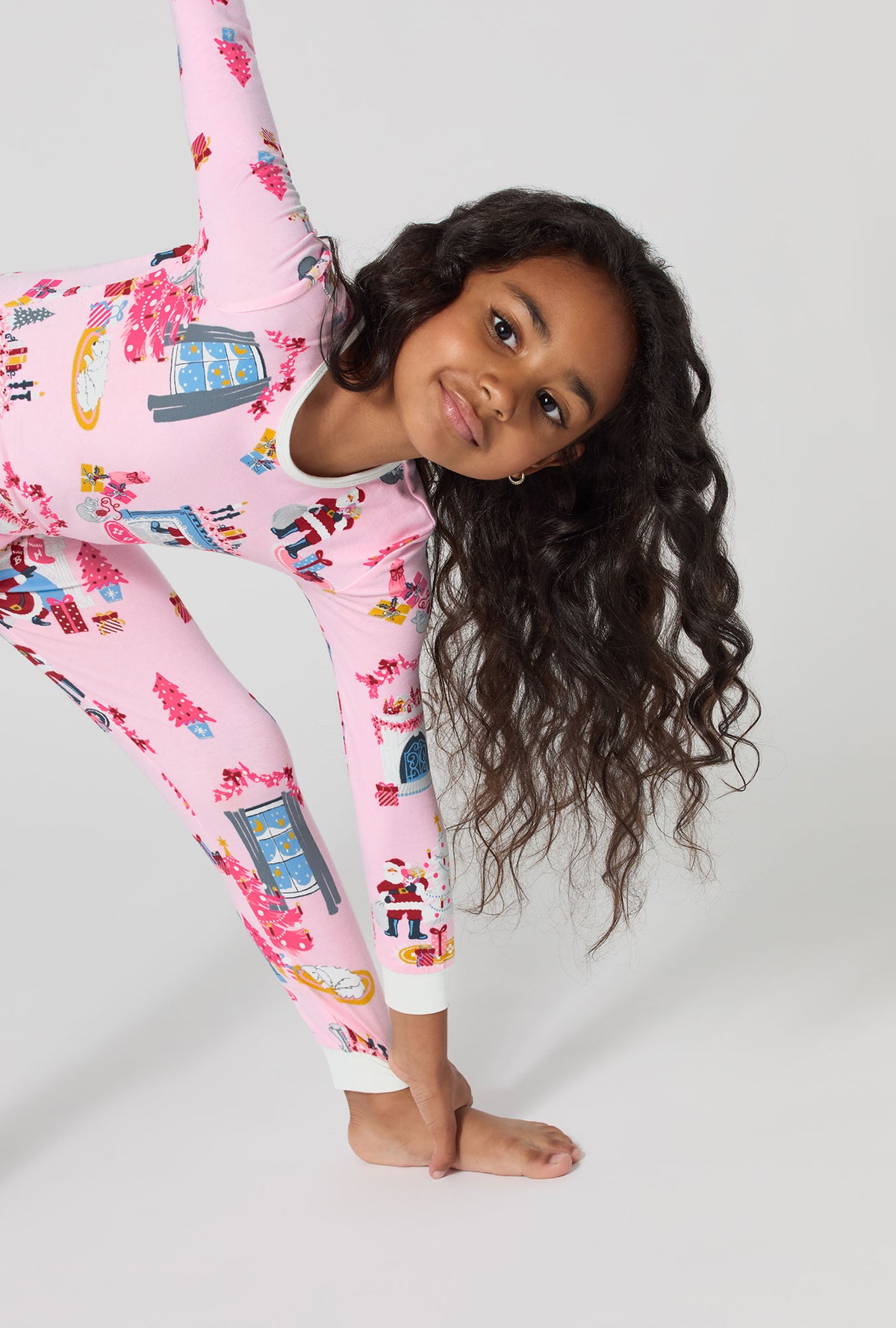 A girl wearing Must Be Santa Long Sleeve Stretch Jersey Kids Pj Set