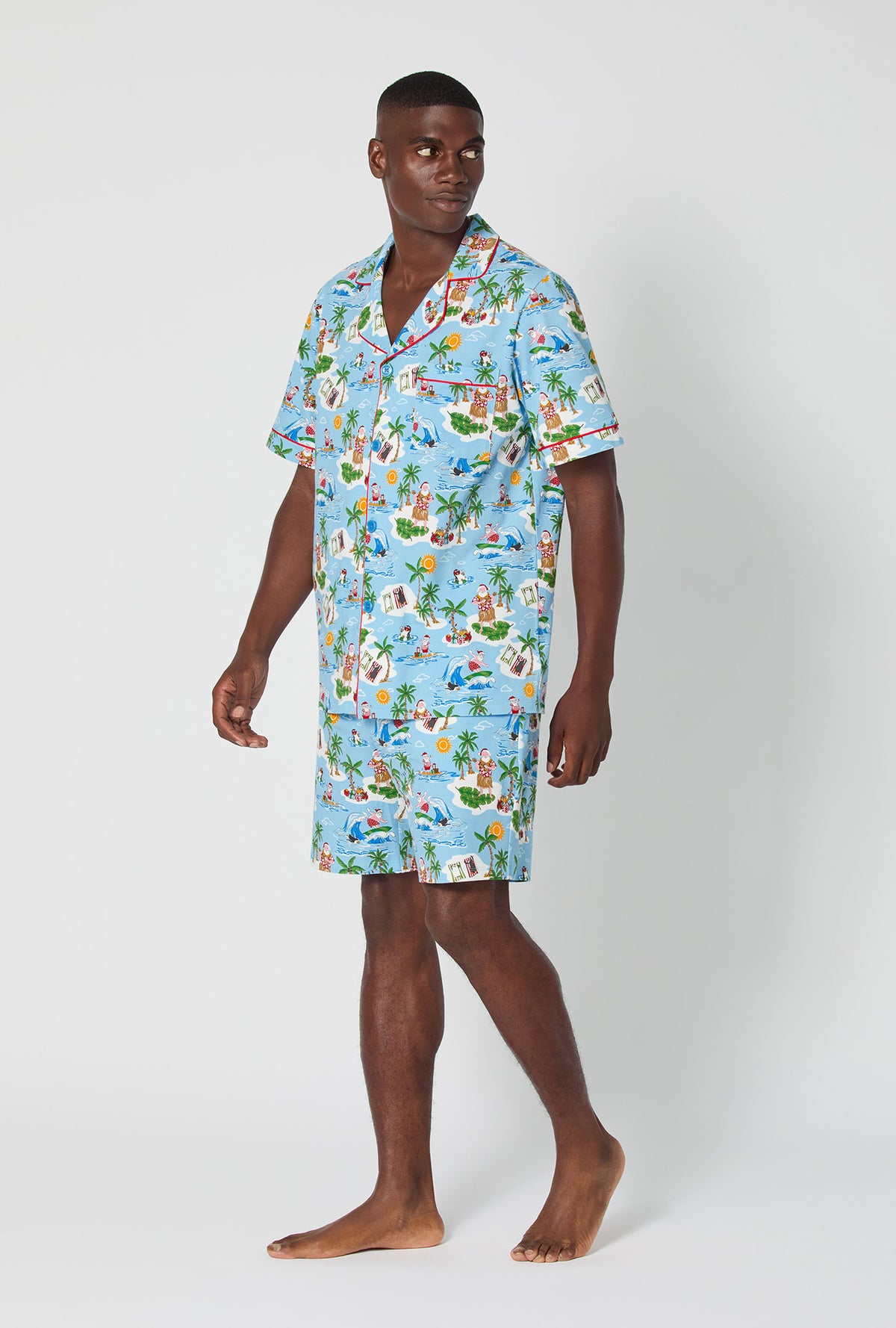 A man wearing Surfin&#39; Santa Men&#39;s Short Sleeve Classic Stretch Jersey Short Pj Set