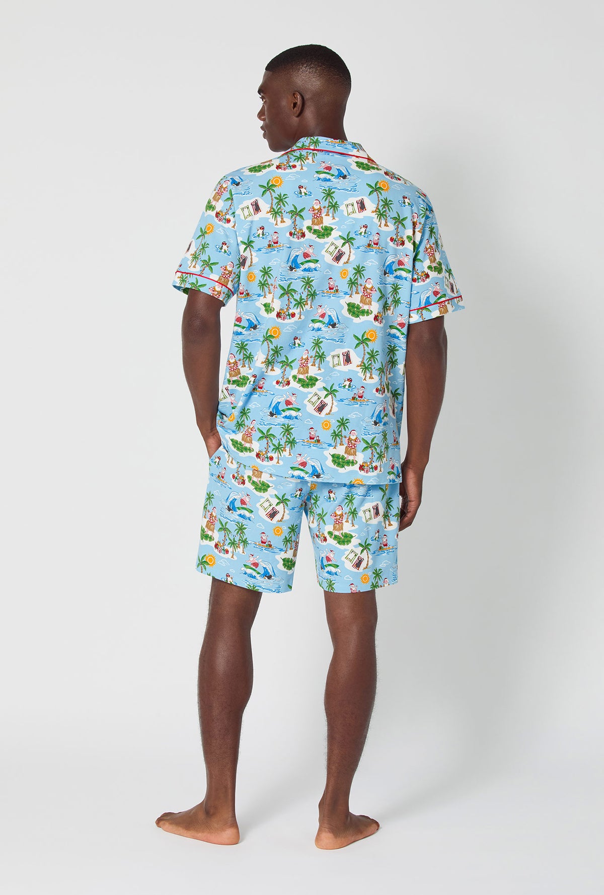 A man wearing Surfin&#39; Santa Men&#39;s Short Sleeve Classic Stretch Jersey Short Pj Set