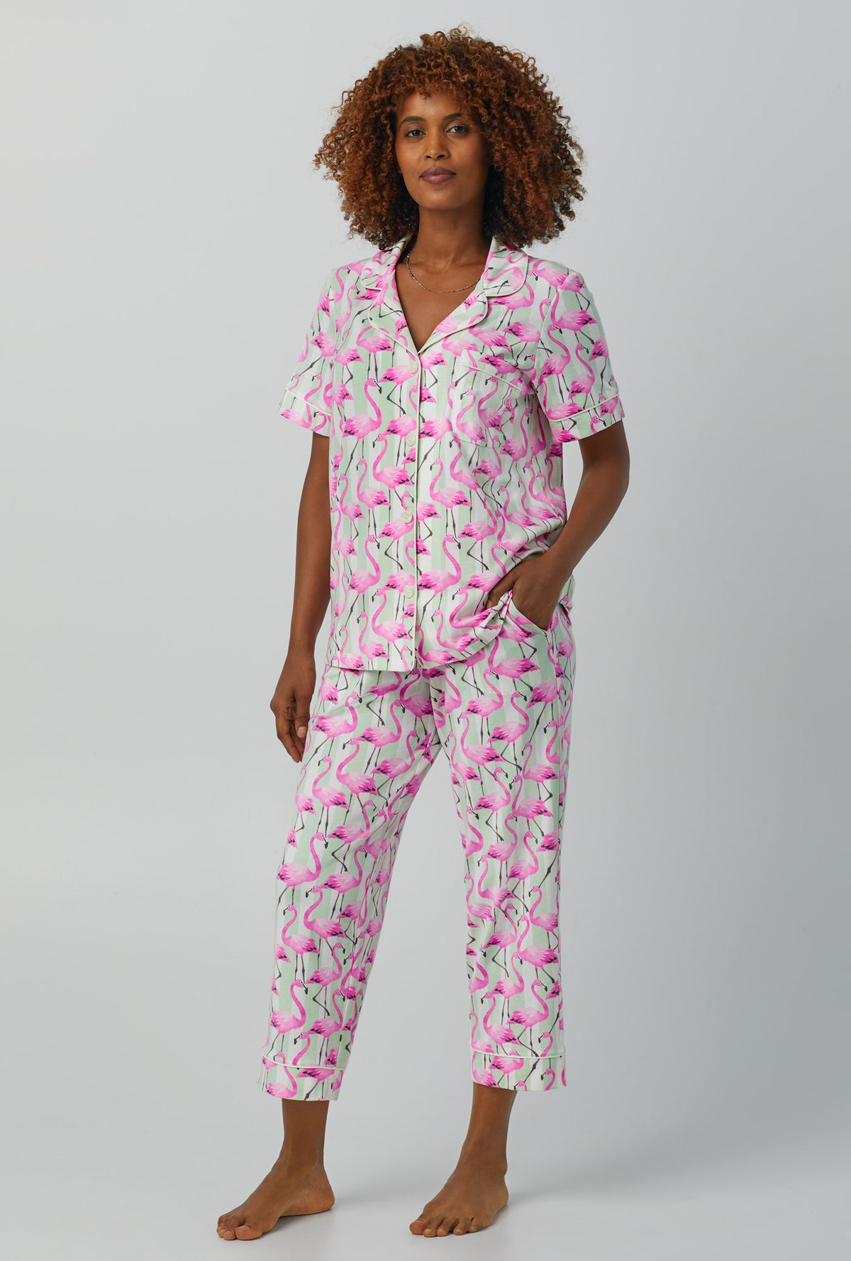 A lady wearing pink Short Sleeve Classic Stretch Jersey Cropped PJ Set with Flamingo Bay print