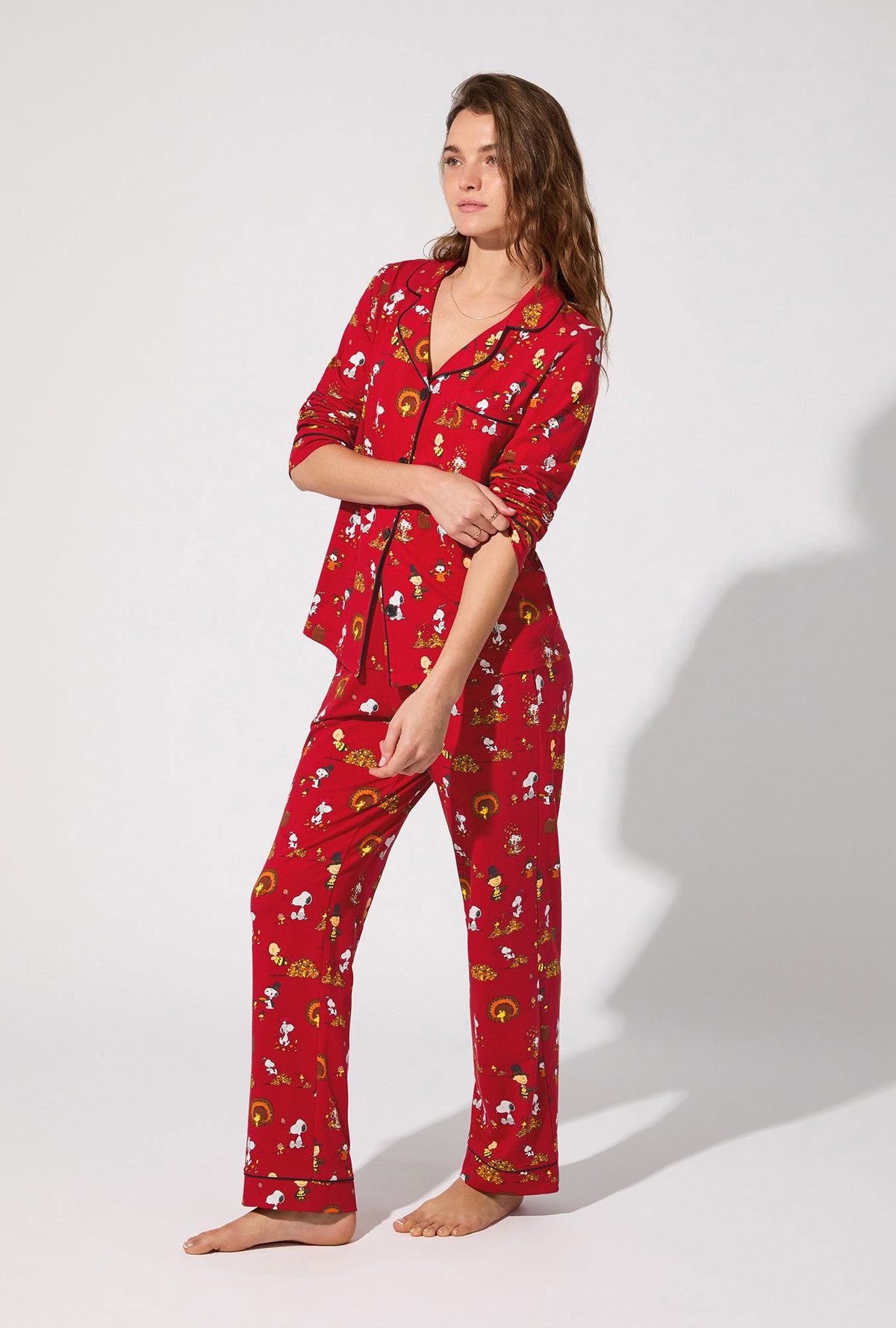 A lady wearing Peanuts® Snoopy&#39;s Thanksgiving Long Sleeve Classic Stretch Jersey PJ Set