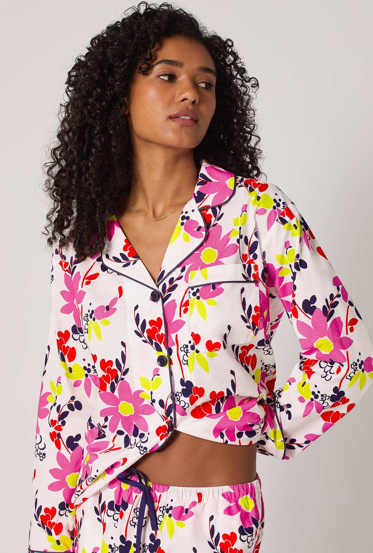 A lady wearing BedHead x Trina Turk Whimsical Floral Long Sleeve Classic Woven Cotton Poplin Pj Set
