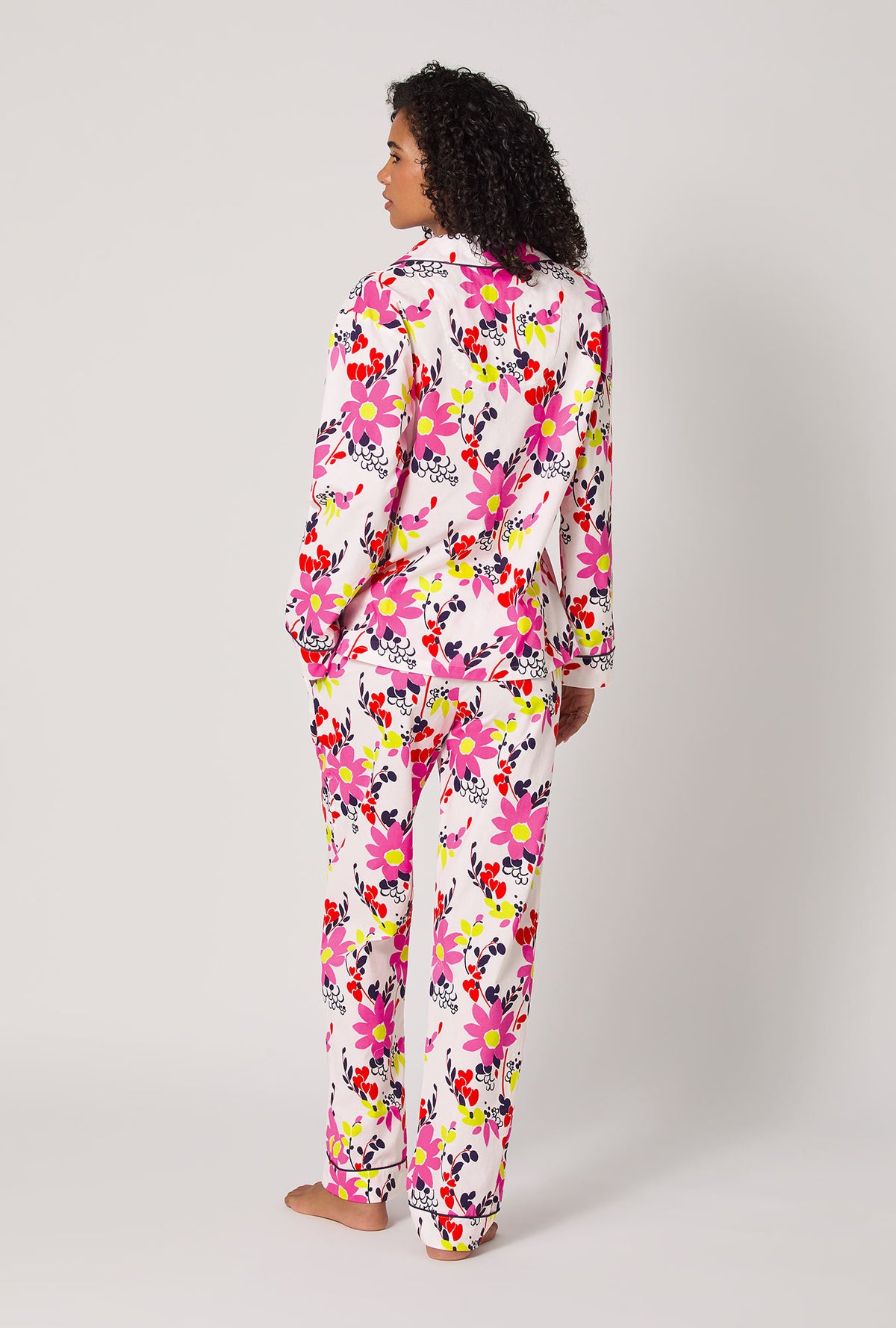 A lady wearing BedHead x Trina Turk Whimsical Floral Long Sleeve Classic Woven Cotton Poplin Pj Set