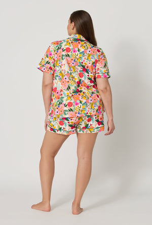 A lady wearing plus size Rifle Paper Co. x BedHead PJs Garden Party Short Sleeve Classic Shorty Stretch Jersey Pj Set back view