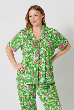 A Lady Wearing Plus Size Monstera Bloom Short Sleeve Classic Stretch Jersey Cropped Pj Set posing in a close up view