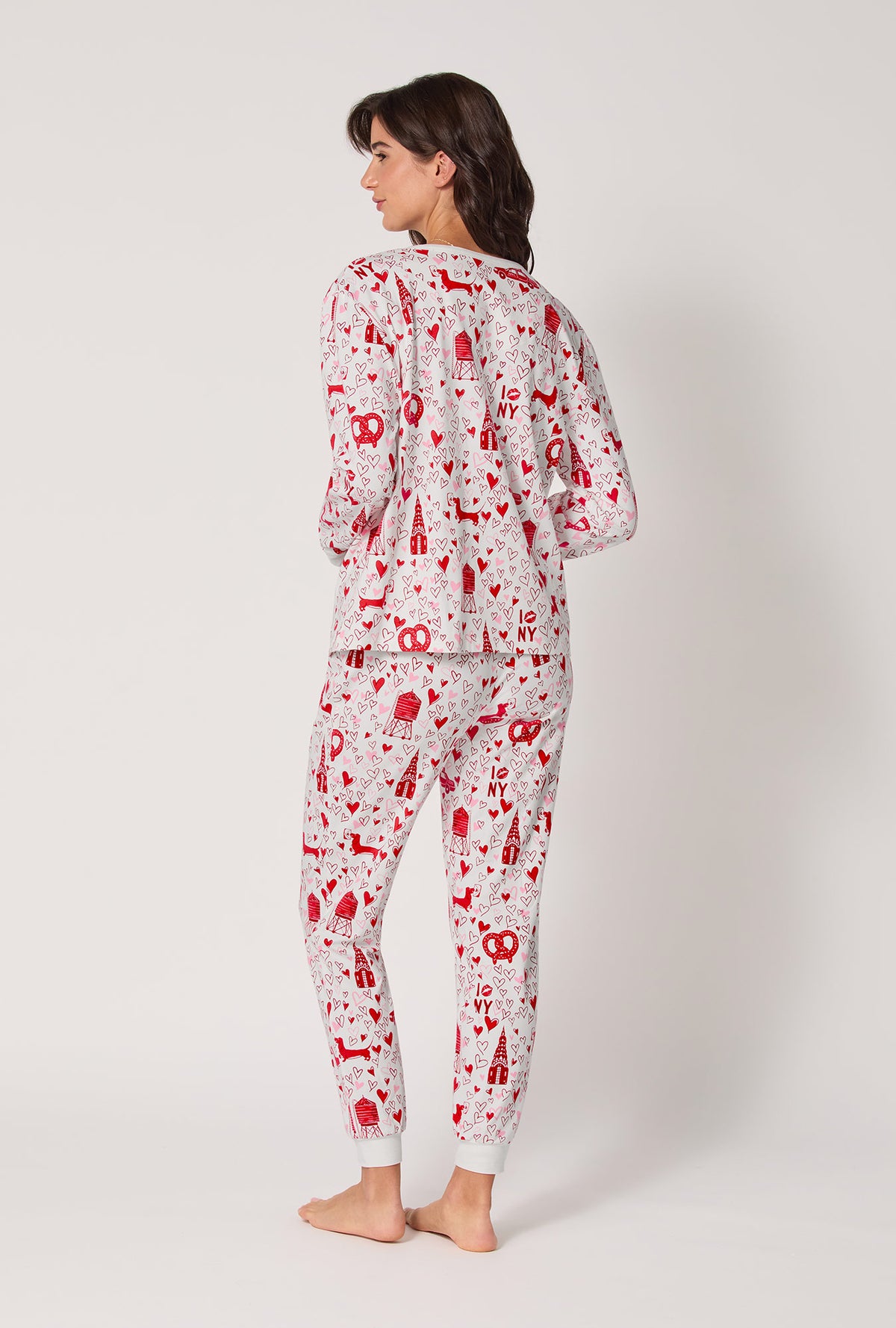 A lady wearing Heart Of The City Long Sleeve Pullover Crew And Jogger Stretch Jersey Pj Set