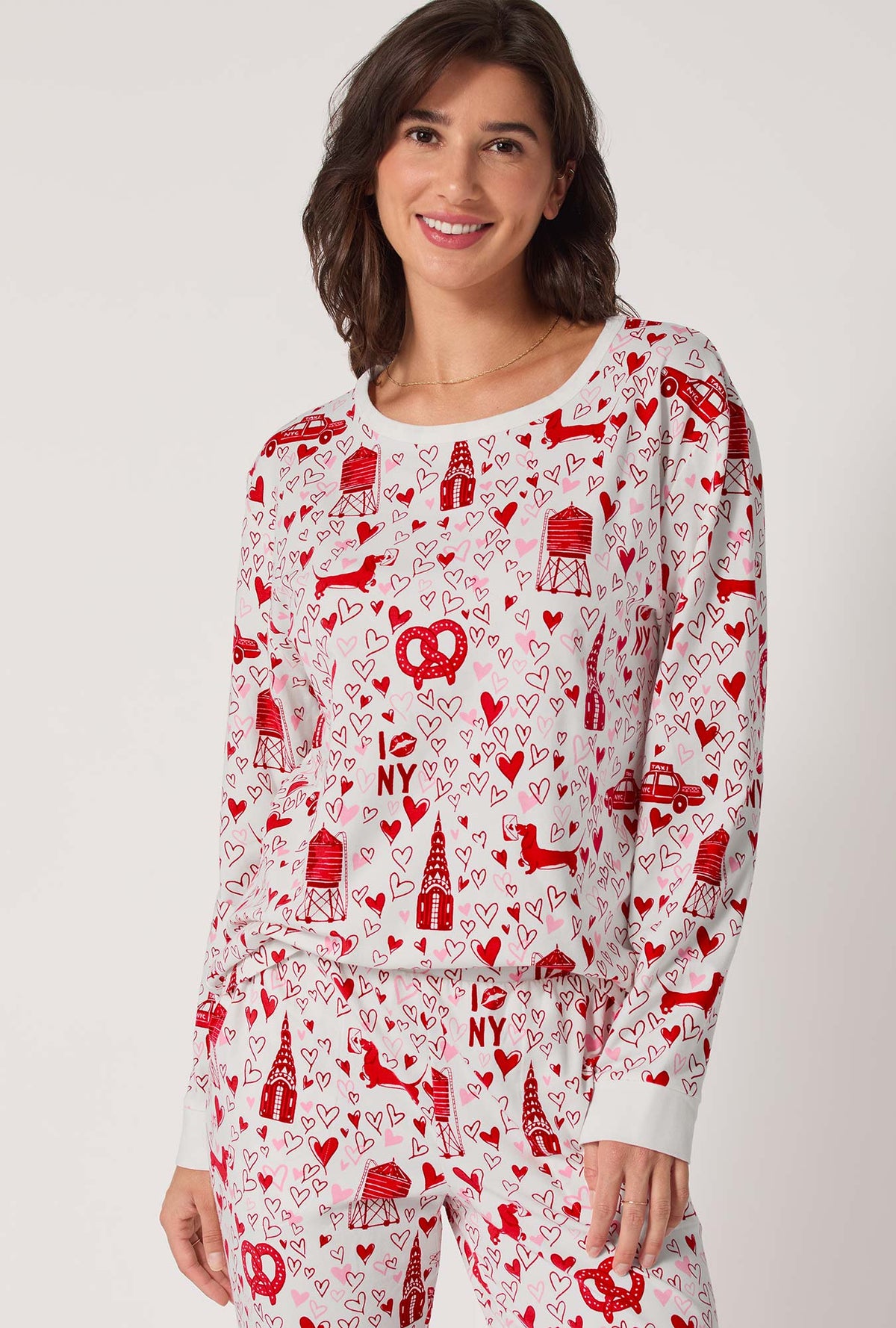 A lady wearing Heart Of The City Long Sleeve Pullover Crew And Jogger Stretch Jersey Pj Set