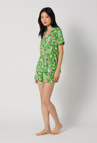 A Lady Wearing Monstera Bloom Short Sleeve Classic Shorty Stretch Jersey Pj Set facing front in a side angle look