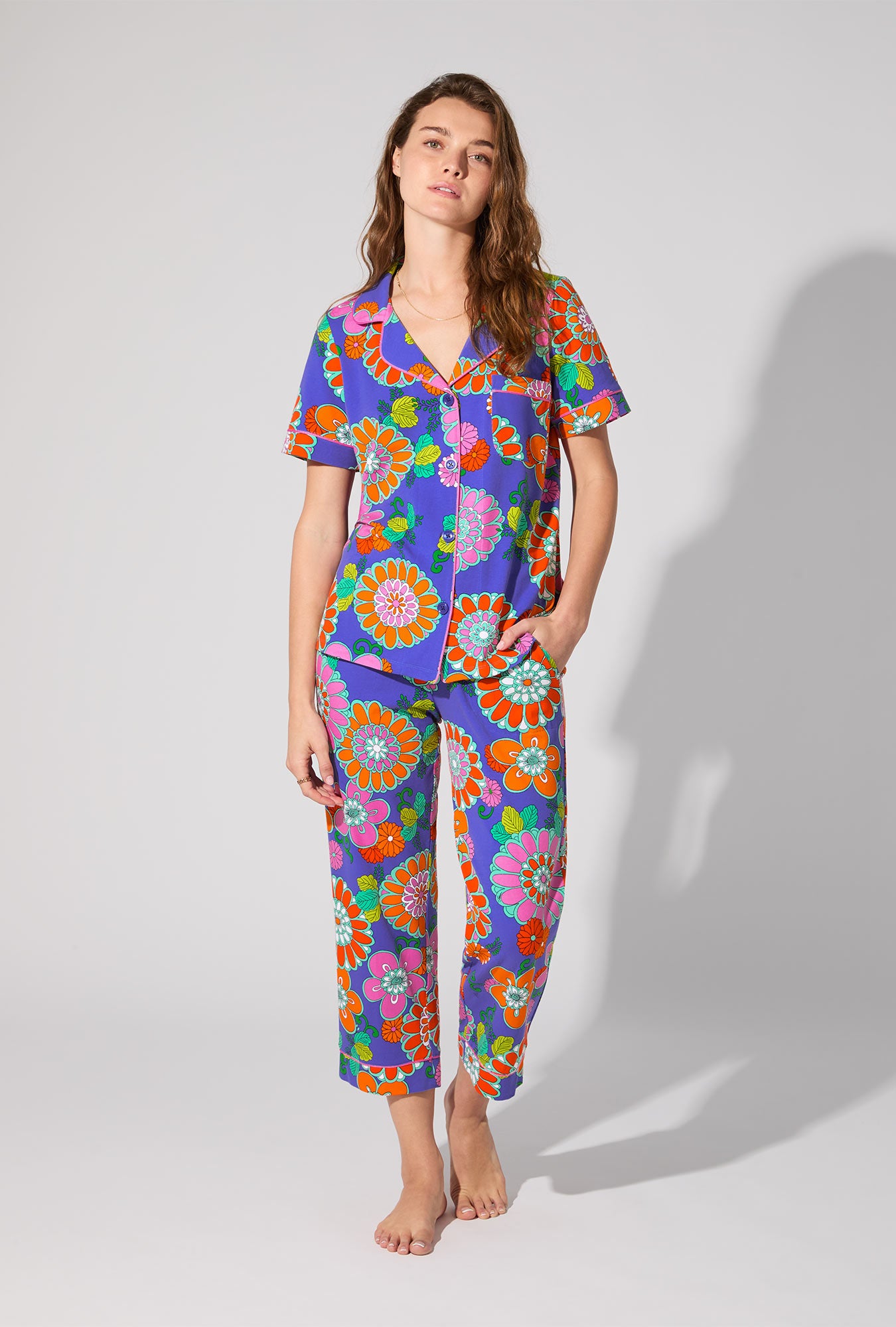 A lady wearing BedHead X Trina Turk Tokyo Floral Short Sleeve Classic Stretch Jersey Cropped PJ Set