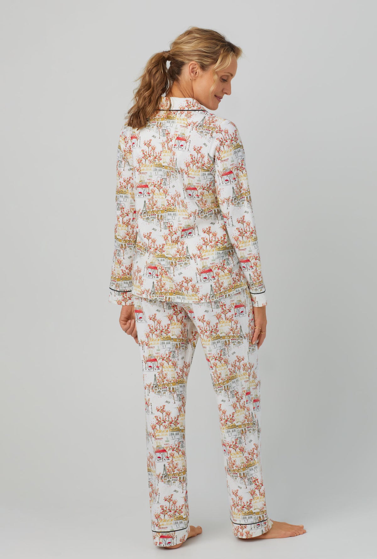 A lady wearing long sleeve classic stretch jersey pj set with fall in paris print.