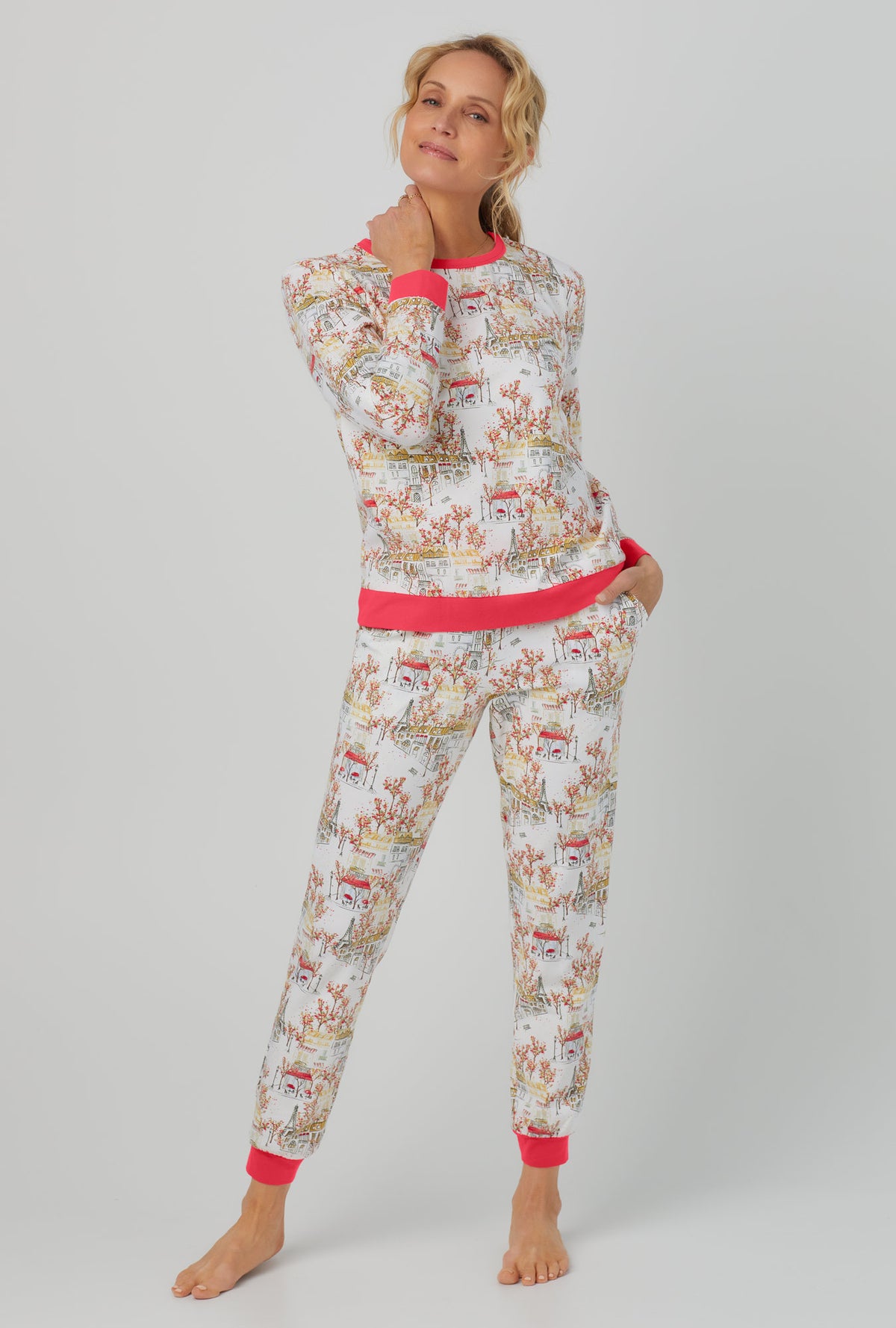 A lady wearing Long Sleeve Pullover Crew and Jogger Stretch Jersey PJ Set with fall in paris print.