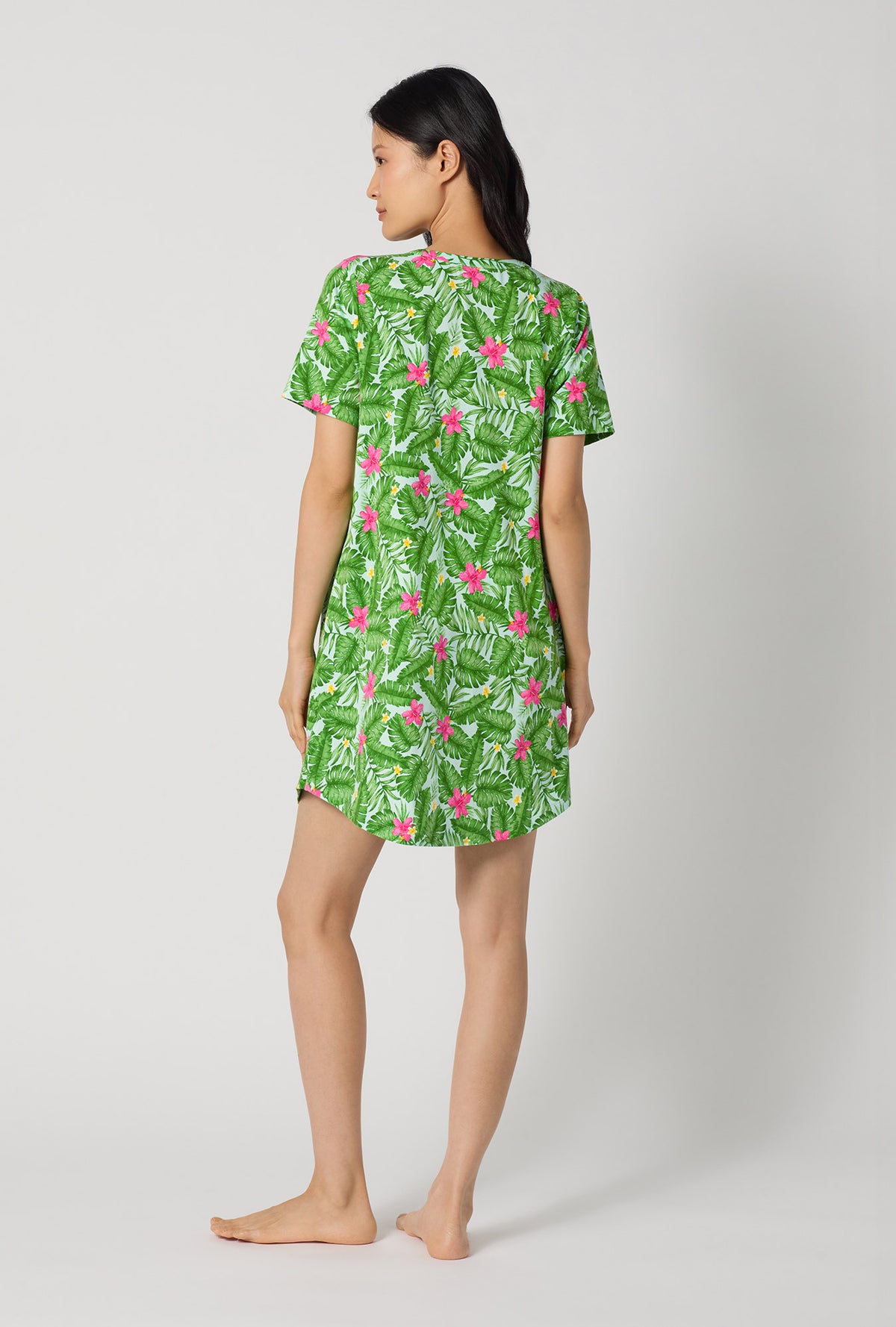 A Lady Wearing Monstera Bloom Stretch Jersey T-shirt Sleep Dress showing the back view of the dress