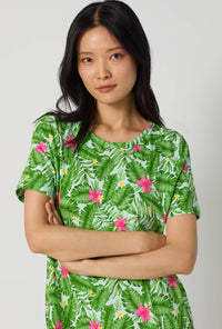 A Lady Wearing Monstera Bloom Stretch Jersey T-shirt Sleep Dress posing in a close up view look