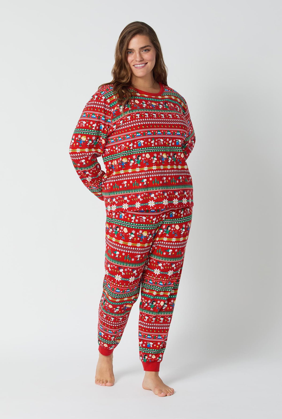 A lady wearing Peanuts®  Winter Fairisle Long Sleeve Pullover Crew And Jogger Stretch Jersey Pj Set