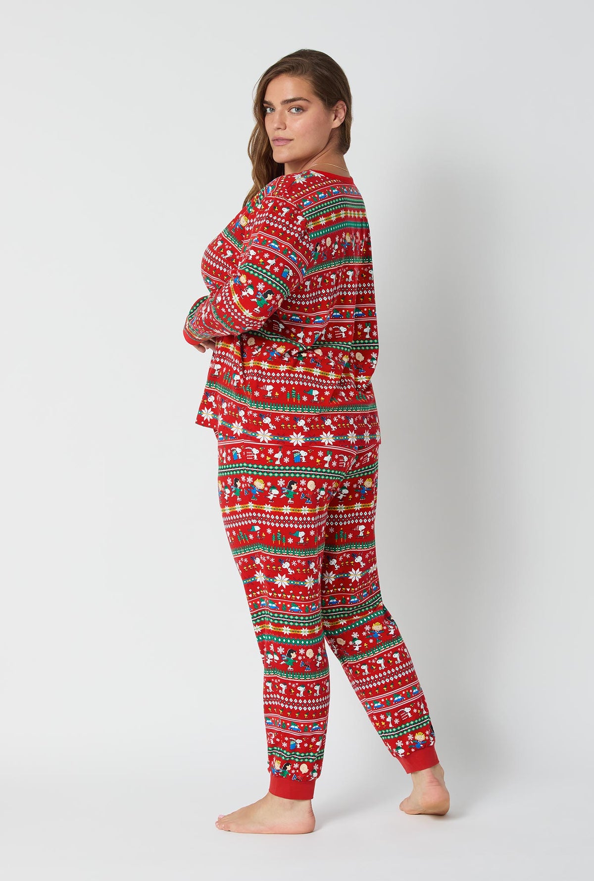 A lady wearing Peanuts®  Winter Fairisle Long Sleeve Pullover Crew And Jogger Stretch Jersey Pj Set