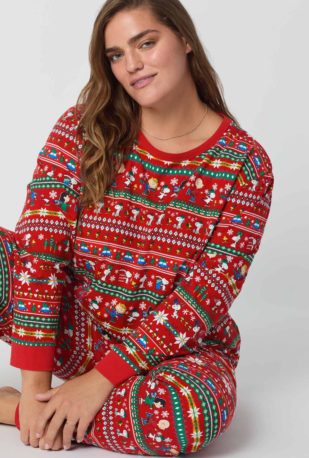 A lady wearing Peanuts®  Winter Fairisle Long Sleeve Pullover Crew And Jogger Stretch Jersey Pj Set