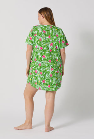 A Lady Wearing Plus Size Monstera Bloom Stretch Jersey T-shirt Sleep Dress posing with a back facing view