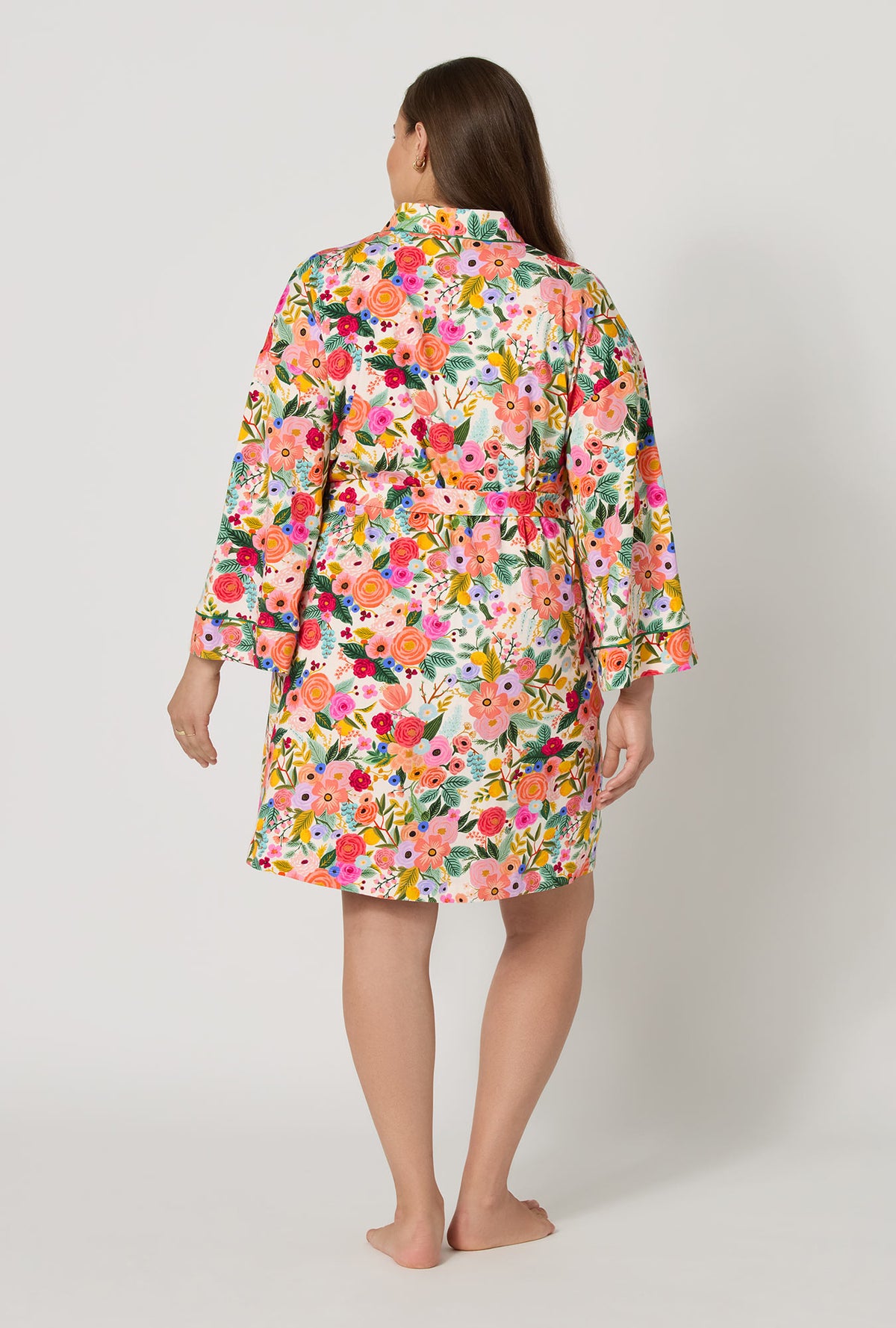 A lady wearing plus size Rifle Paper Co. x BedHead PJs Garden Party Banded Collar Stretch Jersey Robe back view