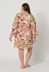 A lady wearing plus size Rifle Paper Co. x BedHead PJs Garden Party Banded Collar Stretch Jersey Robe back view