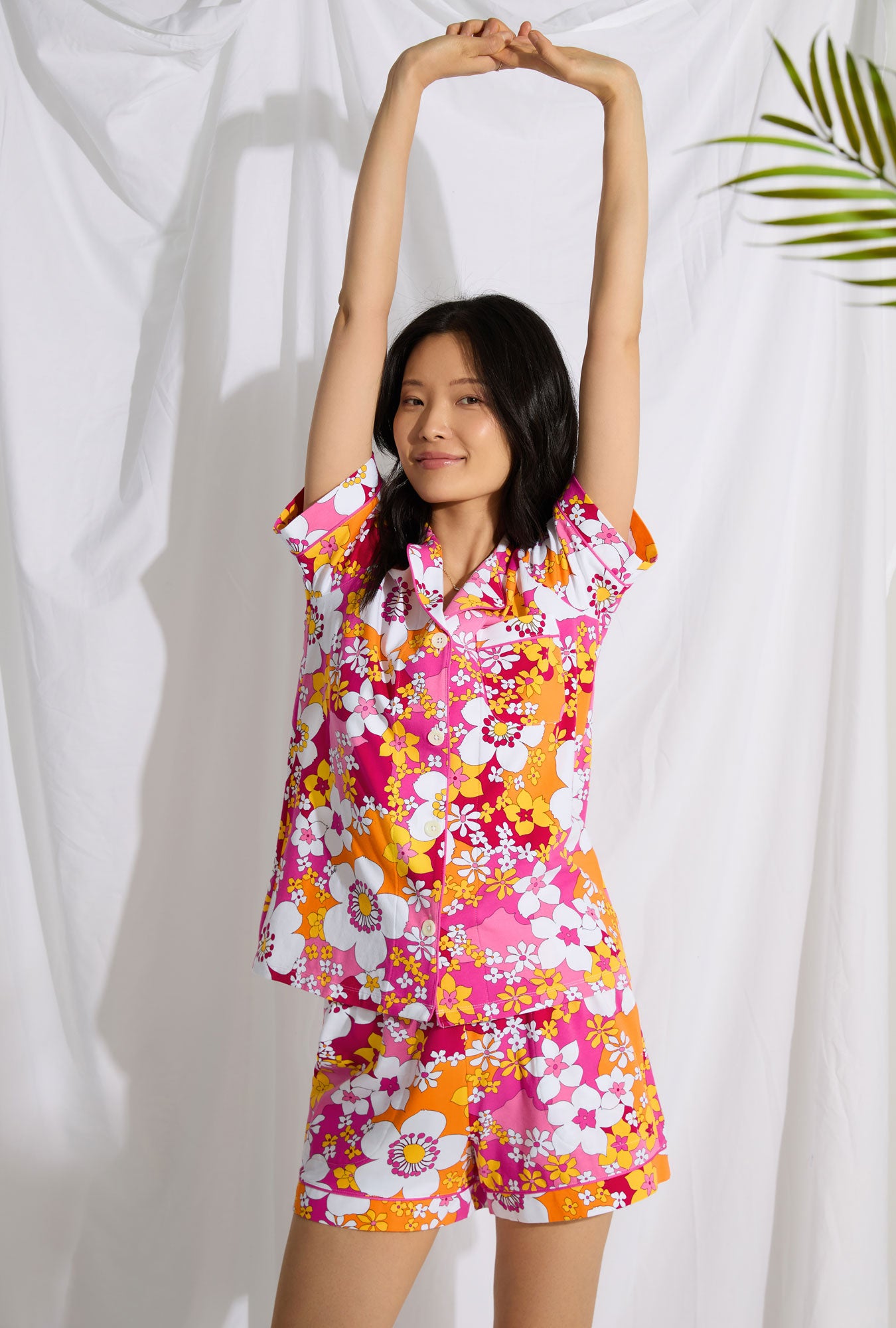 A lady wearing short sleeve classic shorty stretch jersey pj set with bali pink floral print