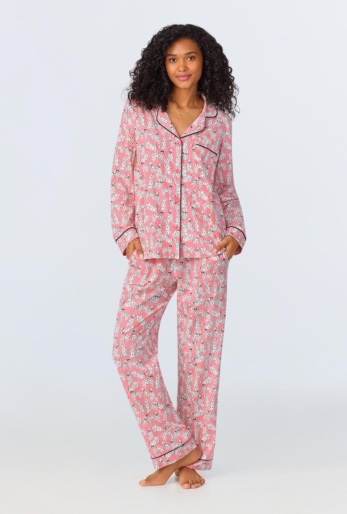 A lady wearing pink long sleeve pajama set with love spot print.