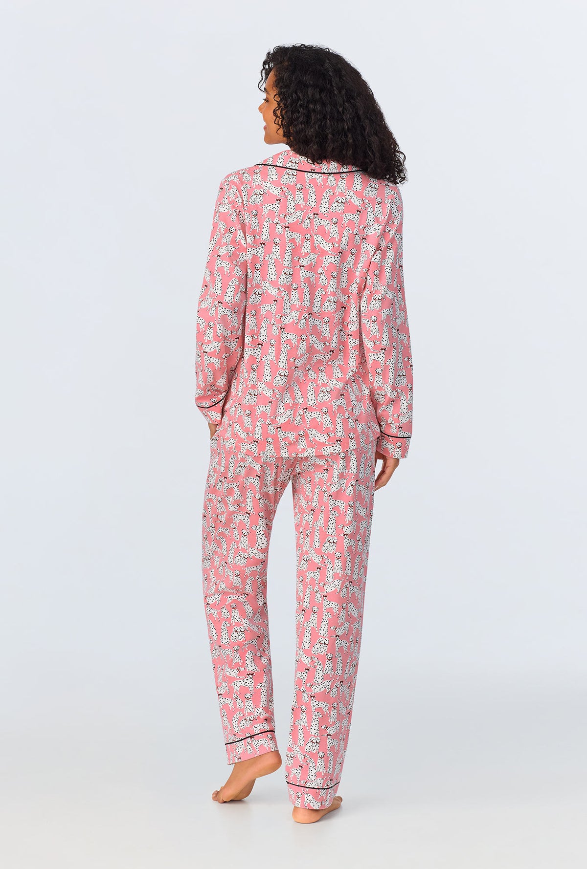 A lady wearing pink long sleeve pajama set with love spot print.