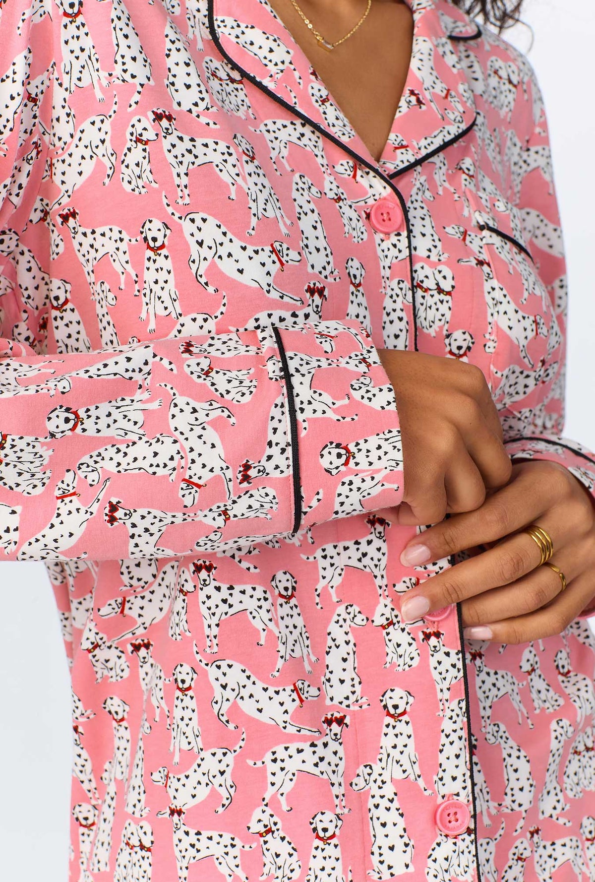 A lady wearing pink long sleeve pajama set with love spot print.