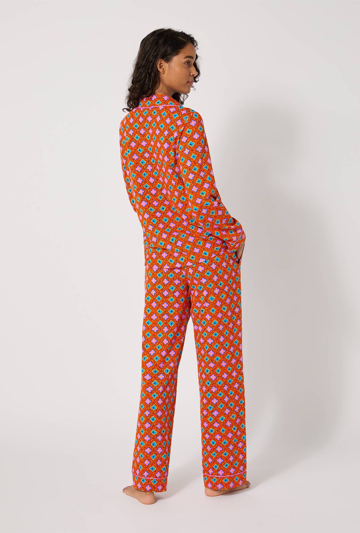 A lady wearing BedHead x Trina Turk Daisy Foulard Long Sleeve Classic Stretch Jersey Pj Set