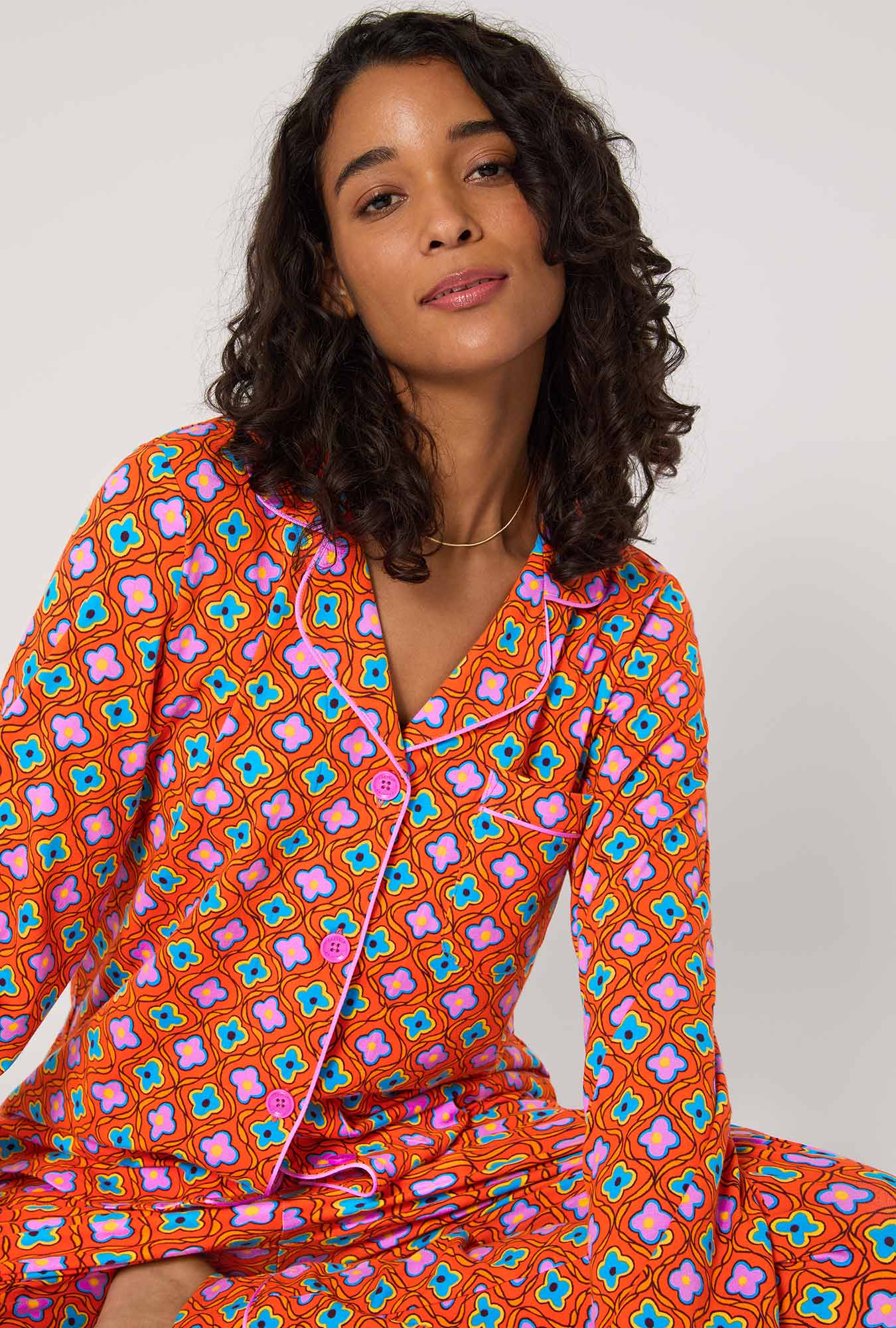 A lady wearing BedHead x Trina Turk Daisy Foulard Long Sleeve Classic Stretch Jersey Pj Set