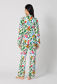 A Lady Wearing Jungle Serenade Long Sleeve Classic Stretch Jersey Pj Set turned back in a full standing pose