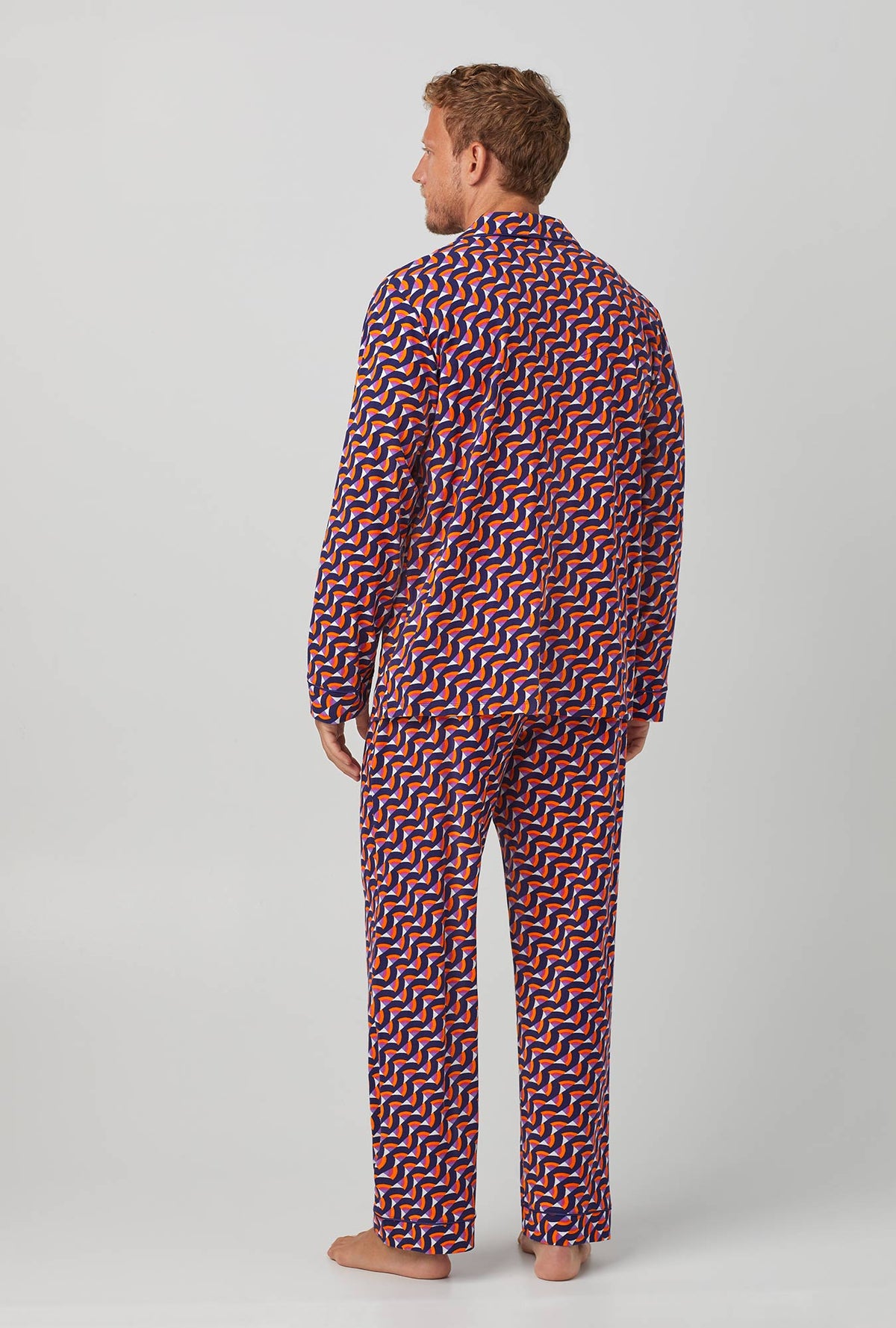 A man wearing Geo Rainbow Men&#39;s Long Sleeve Classic Stretch Jersey PJ Set