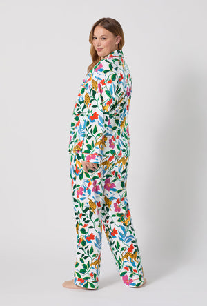 A Lady Wearing Plus Size Jungle Serenade Long Sleeve Classic Stretch Jersey Pj Set in a back view pose while looking back over the shoulder.
