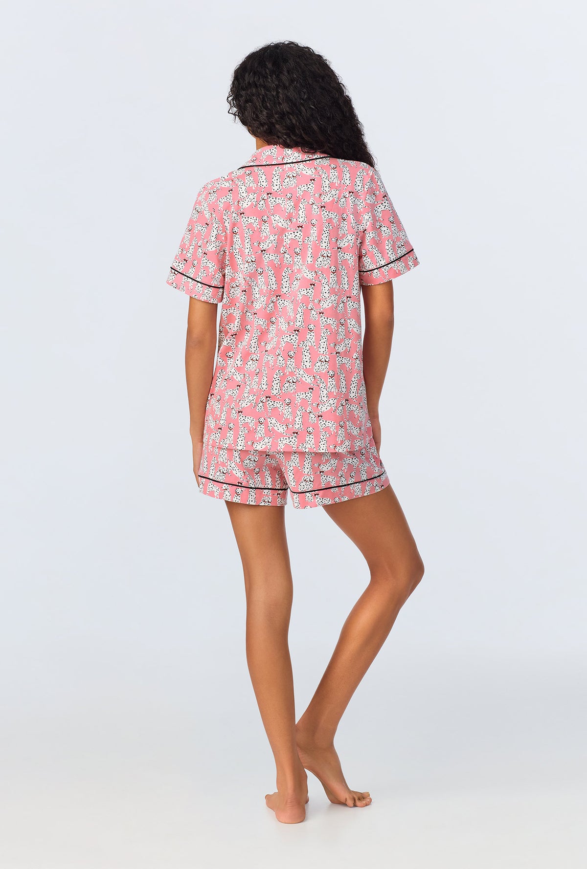 A lady wearing pink short sleeve shorty pj set with love spot print.