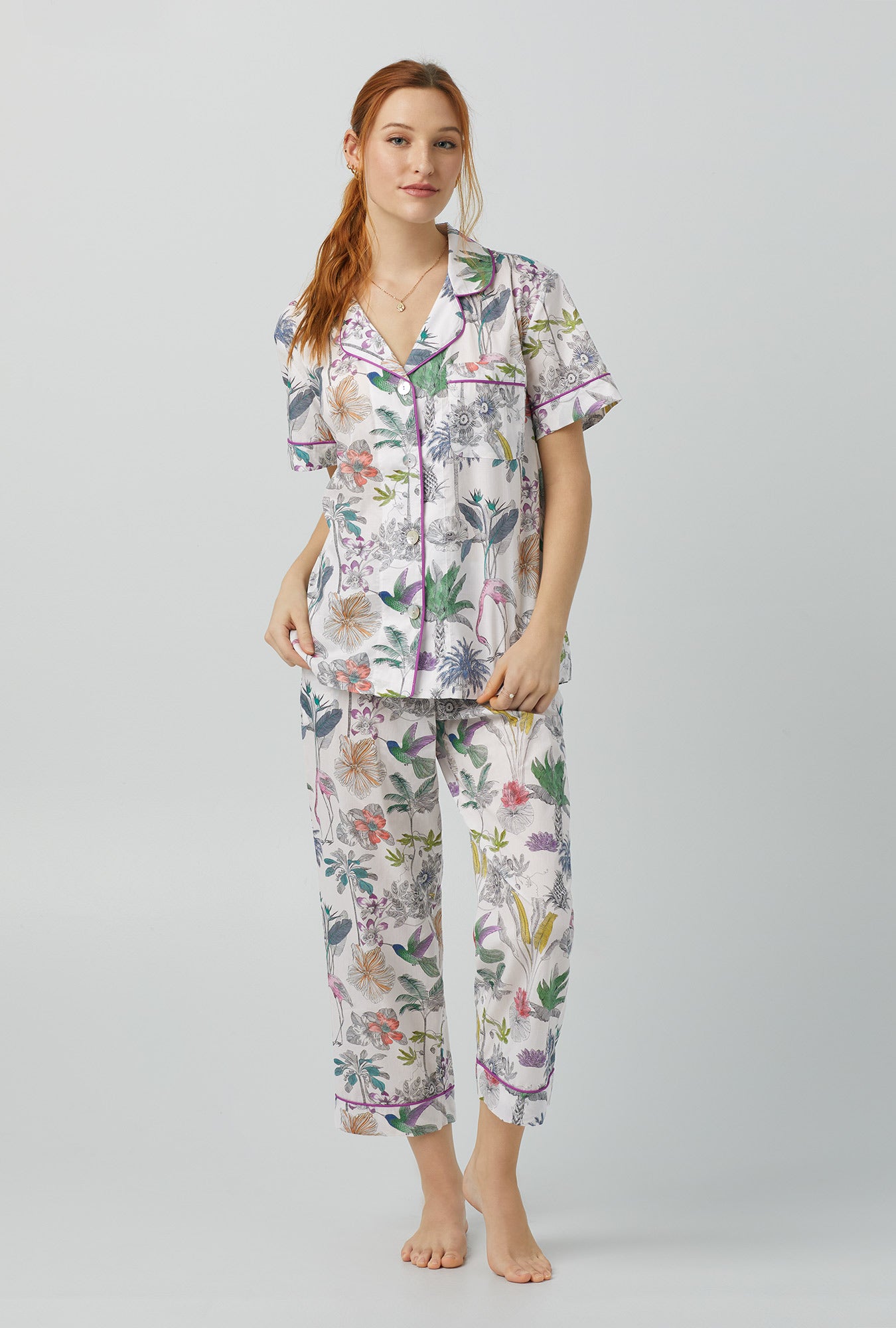 A lady wearing multi color Short Sleeve Classic Woven Cotton Cropped PJ Set with Darwin's Journey print