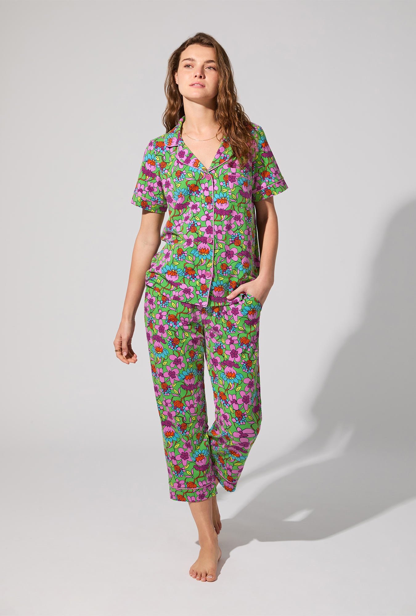 A lady wearing BedHead X Trina Turk Garden Floral Short Sleeve Classic Stretch Jersey Cropped PJ Set