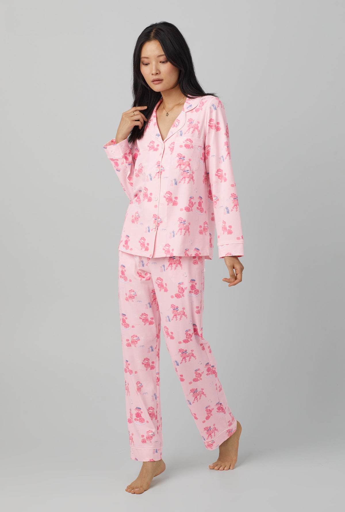 A lady wearing Pink Long Sleeve Classic Stretch Jersey PJ Set with Pampered Poodles  print