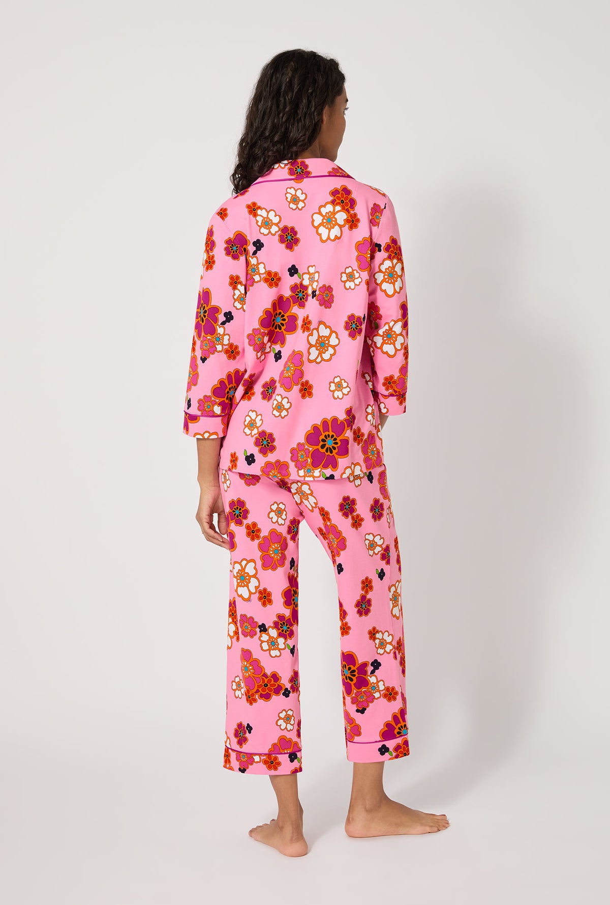 A lady wearing BedHead x Trina Turk Resort Floral 3/4 Sleeve Classic Stretch Jersey Cropped Pj Set