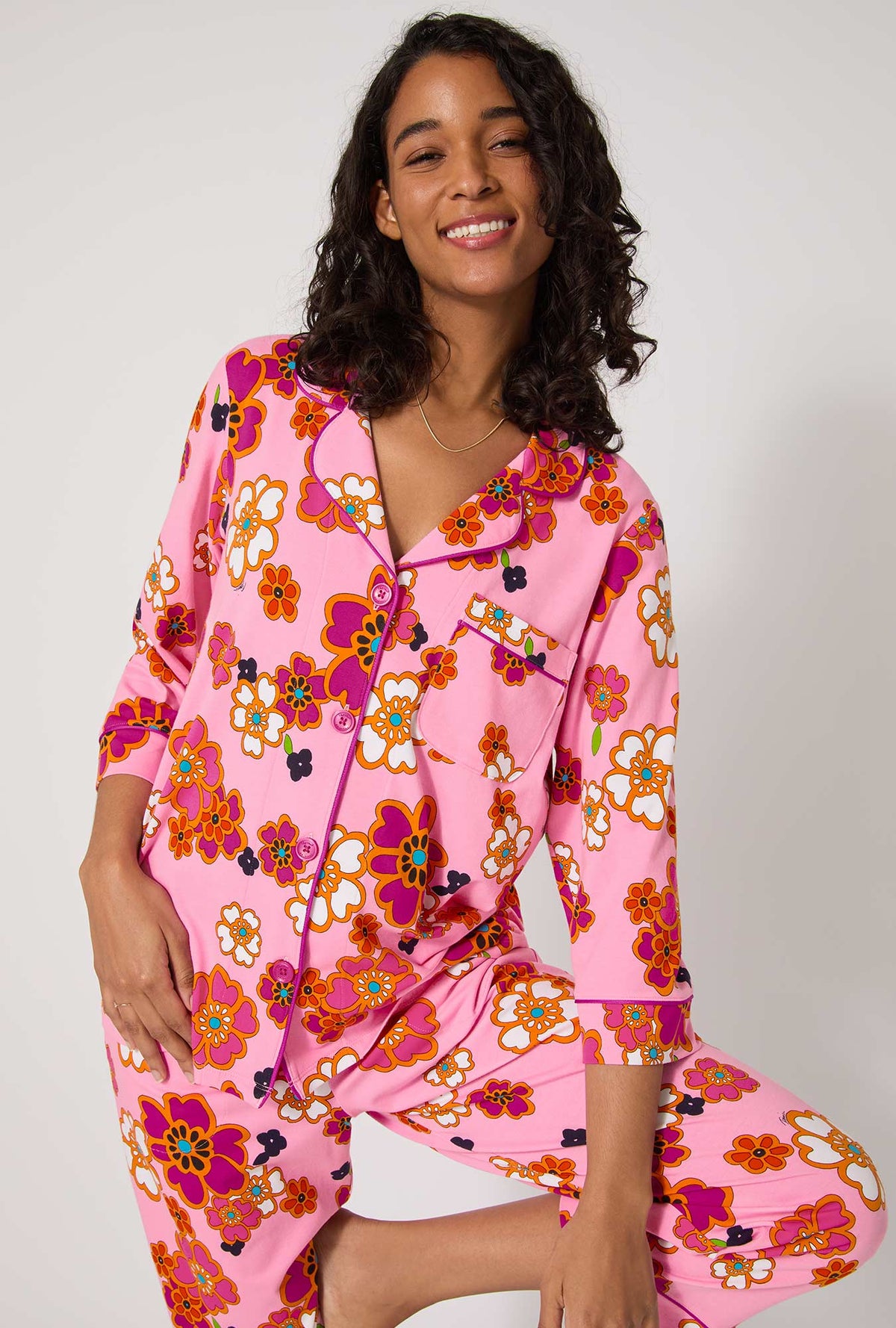 A lady wearing BedHead x Trina Turk Resort Floral 3/4 Sleeve Classic Stretch Jersey Cropped Pj Set