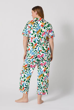A Lady Wearing Plus Size Jungle Serenade Short Sleeve Classic Stretch Jersey Cropped Pj Set facing back while looking to the size