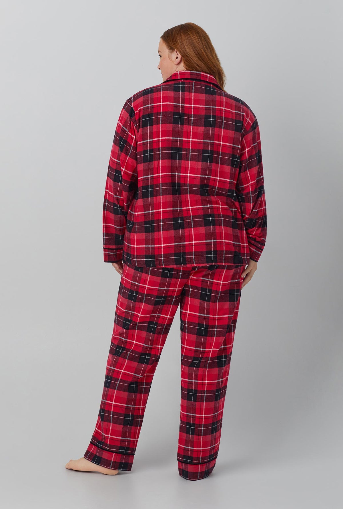 A lady wearing red long sleeve clasic woven cotton flannel plus pj set with nicholas plaid print.