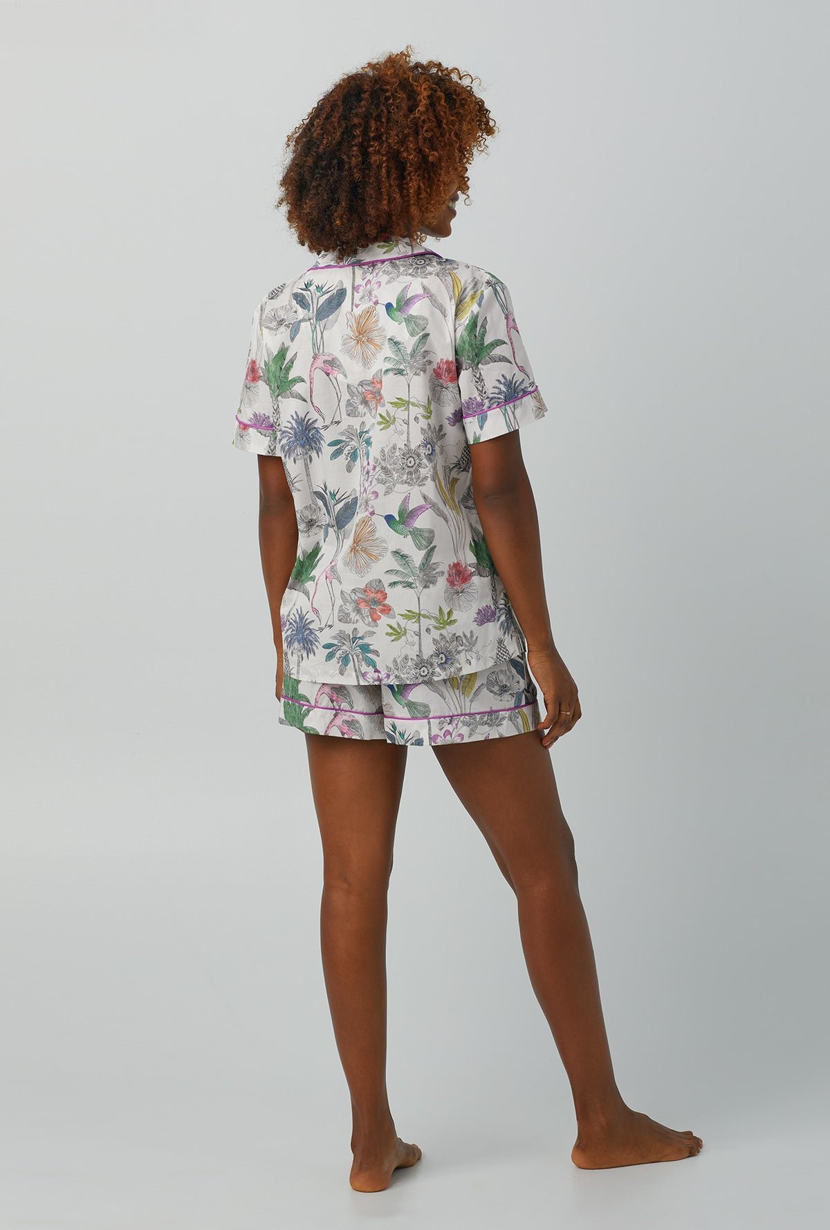 A lady wearing multi color Short Sleeve Classic Woven Cotton Shorty PJ Set with Darwin&#39;s Journey print