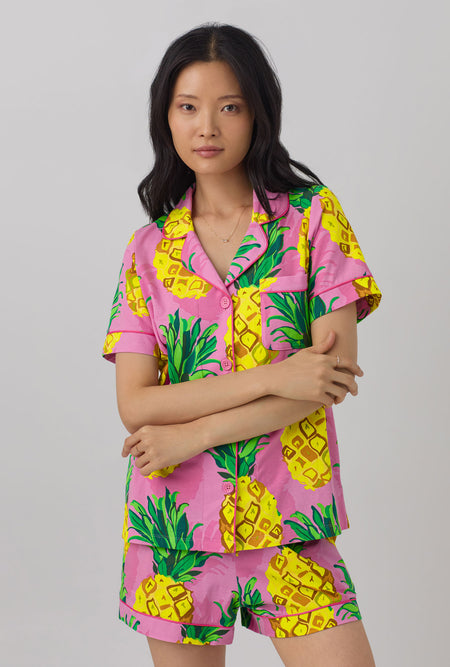 A lady wearing short sleeve classic shorty stretch jerset pj set with pineapple print